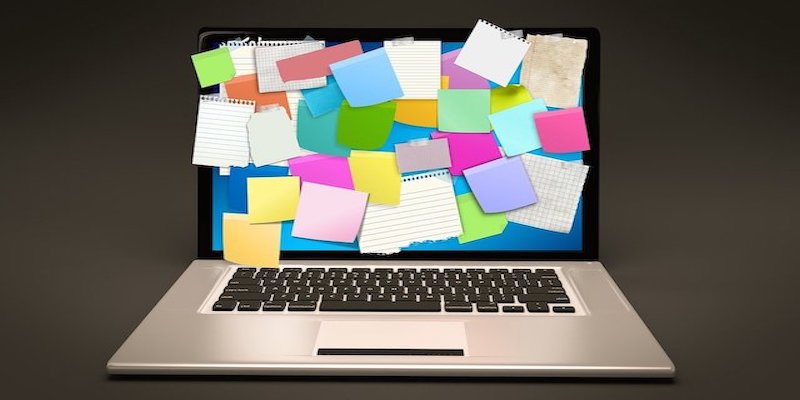 laptop with post it notes on screen
