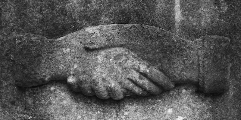 handshake etched in stone